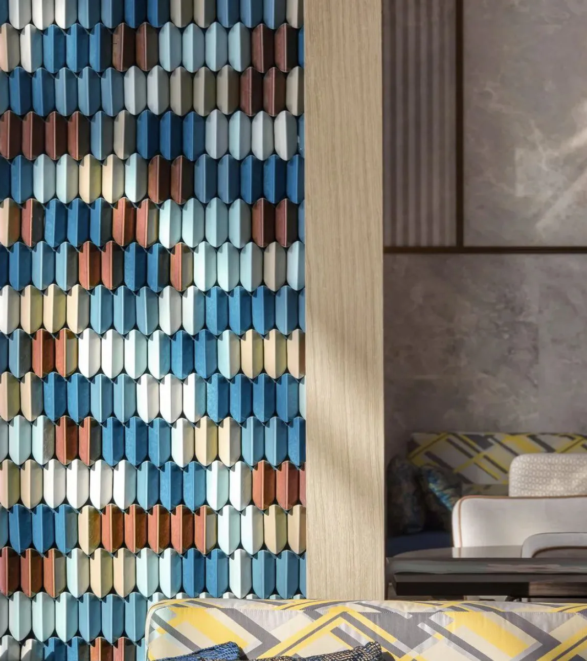 A colorful, dimensional ceramic tile wall beside warm wood and stone finishes.