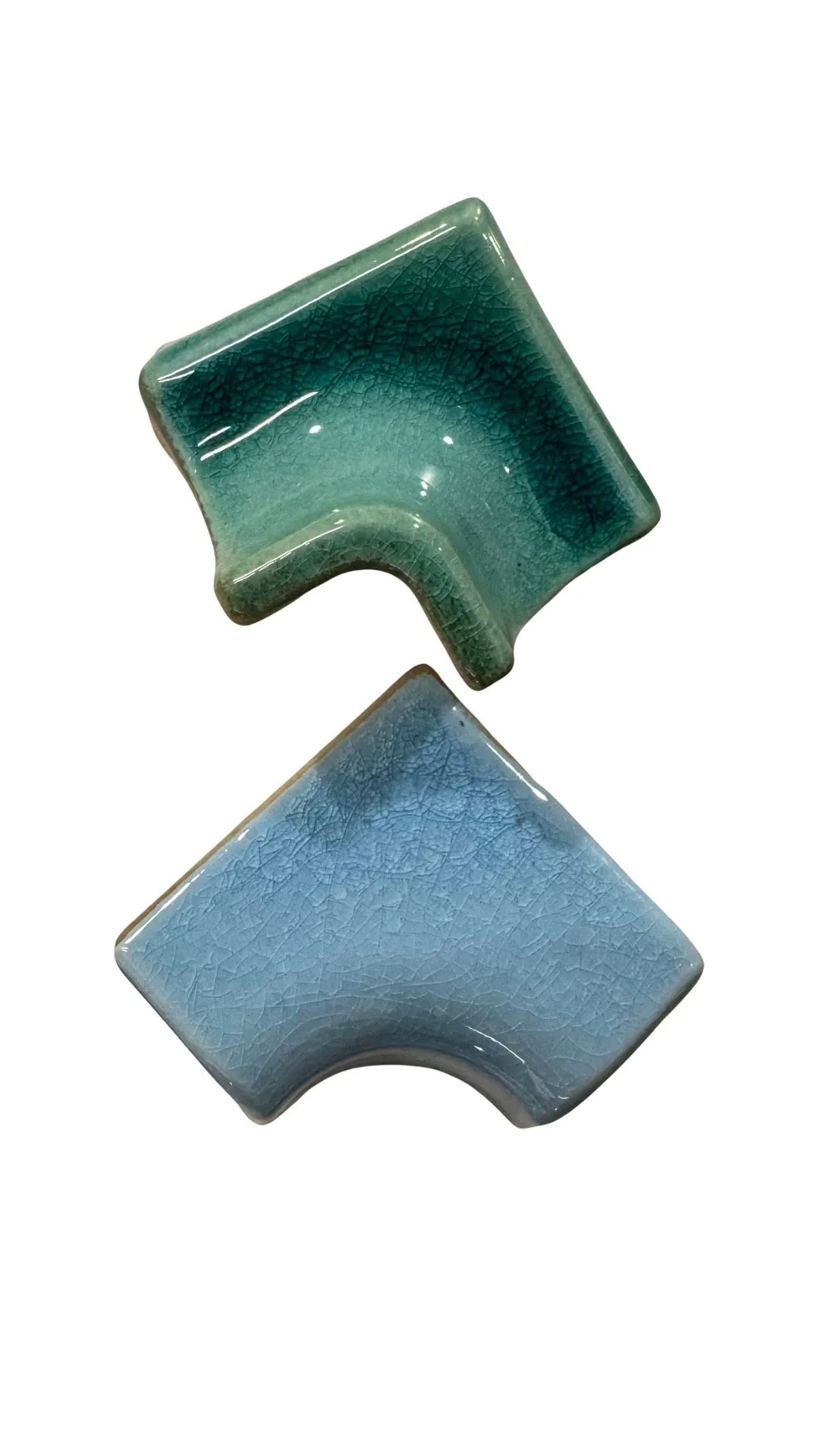Glazed ceramic corner trim tiles in blue tones.