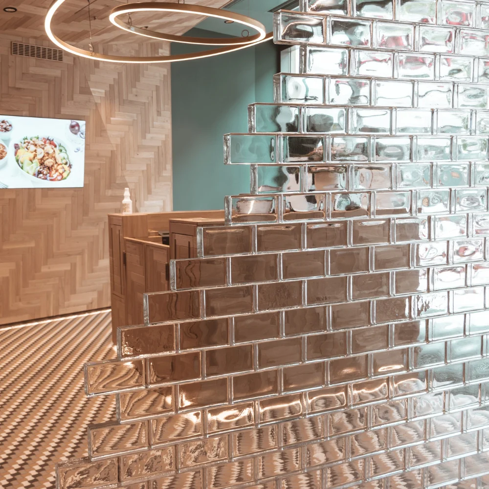 Completed contemporary interior with a stepped partition made from clear glass blocks.