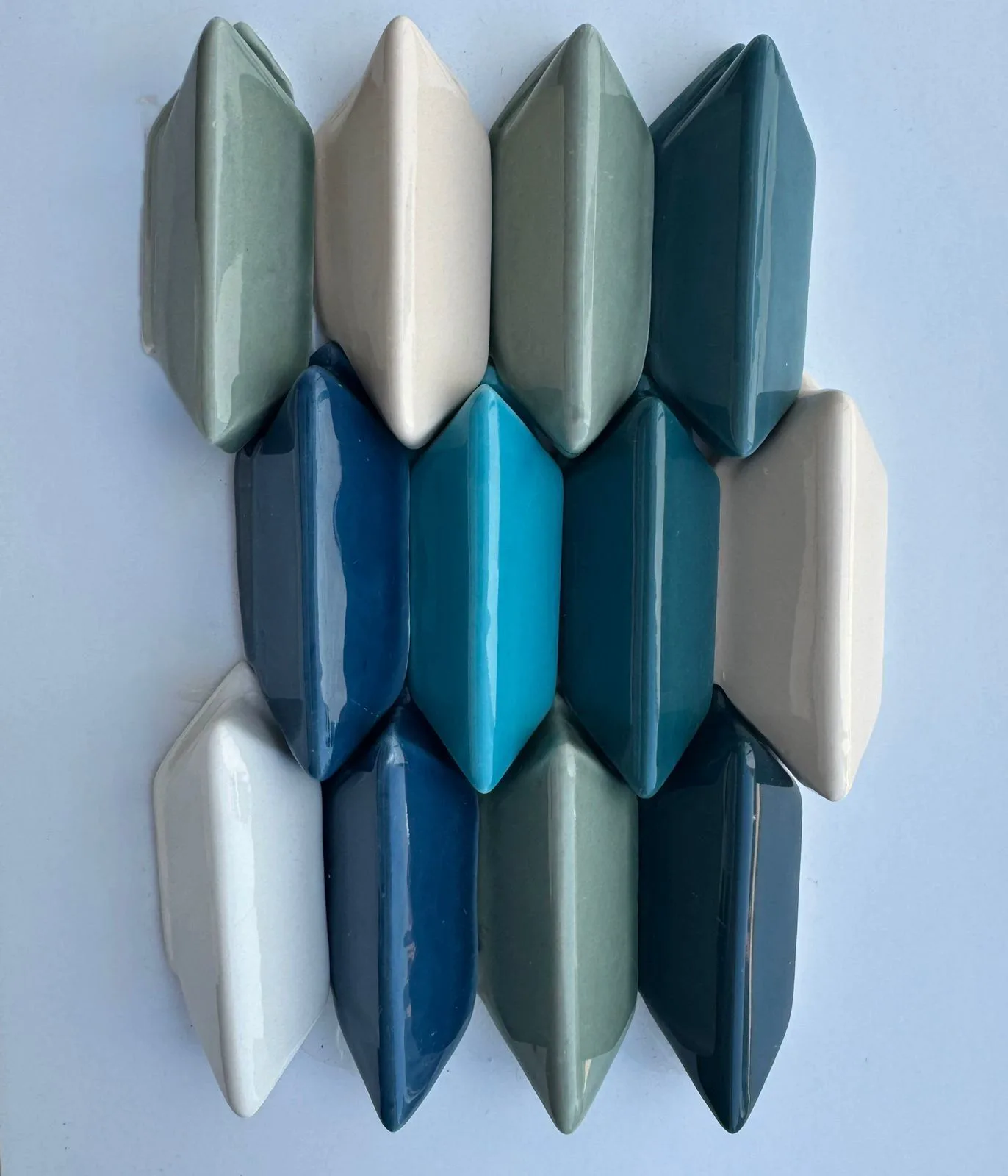 Blue, green, and white 3D glazed ceramic wall tile mosaic.