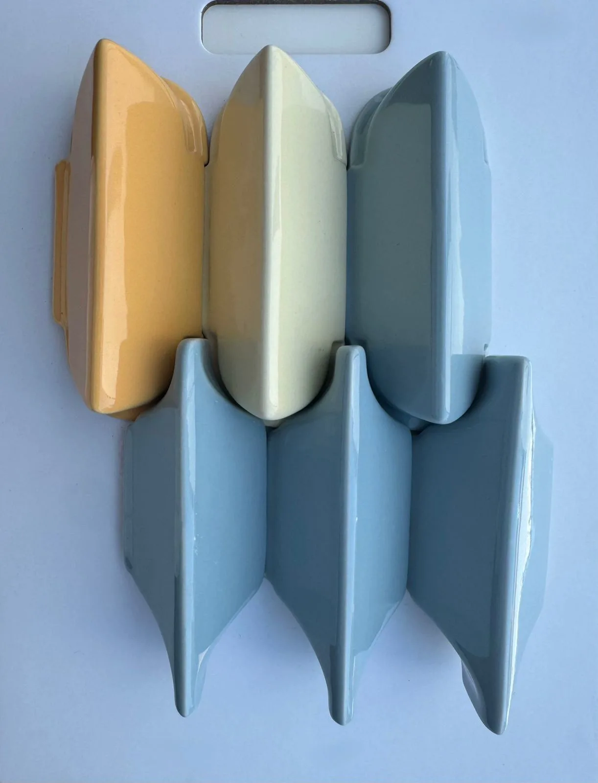 Yellow, cream, and blue 3D glazed ceramic wall tile mosaic.