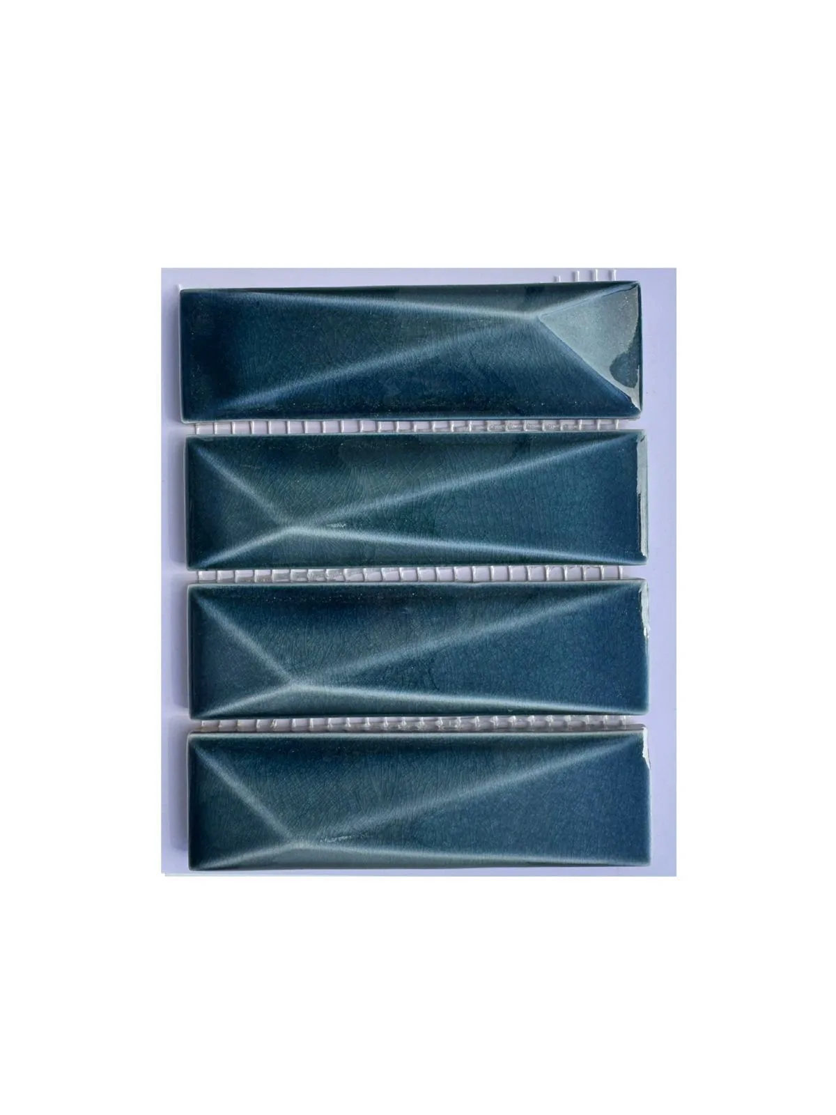 Deep teal faceted ceramic mosaic pieces.