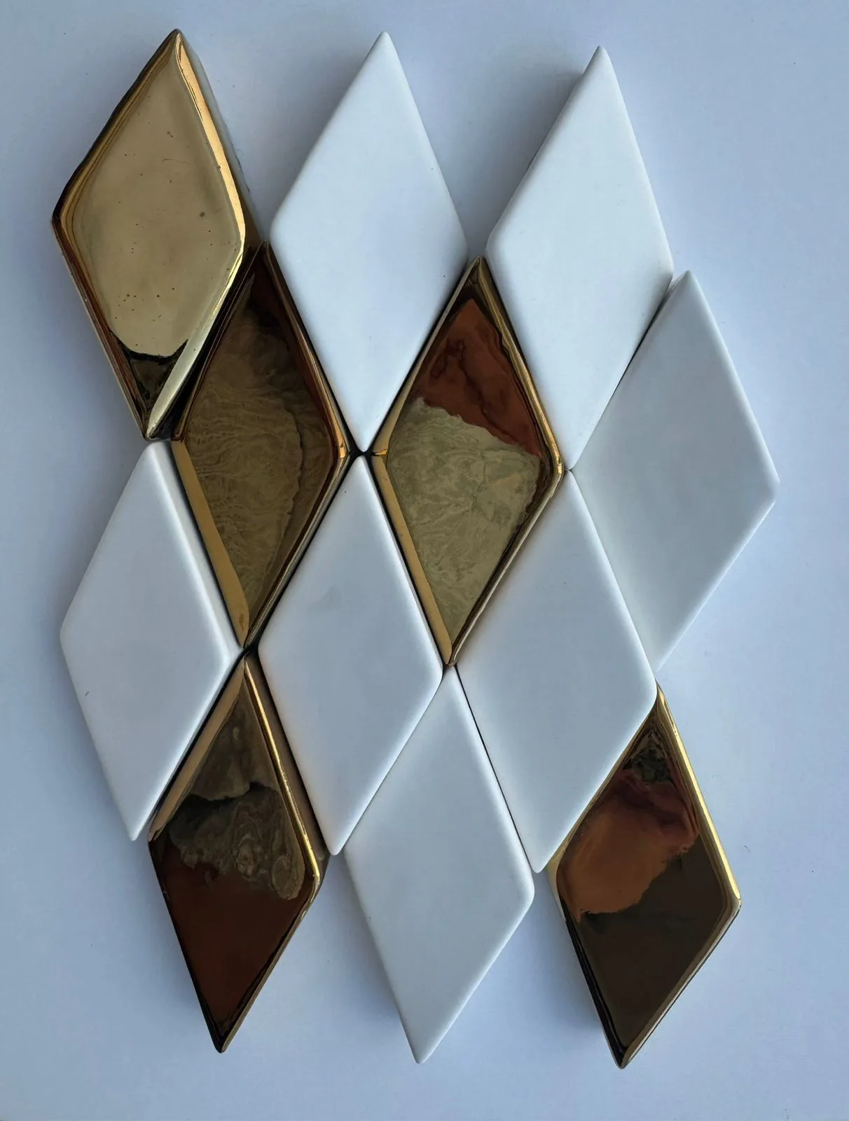 White and metallic gold diamond-shaped glazed ceramic wall tile mosaic.