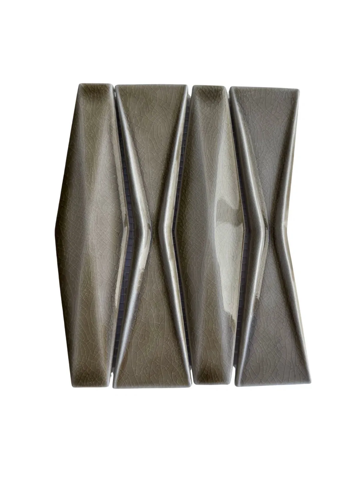 Grey glazed ceramic mosaic pieces with an angled texture.