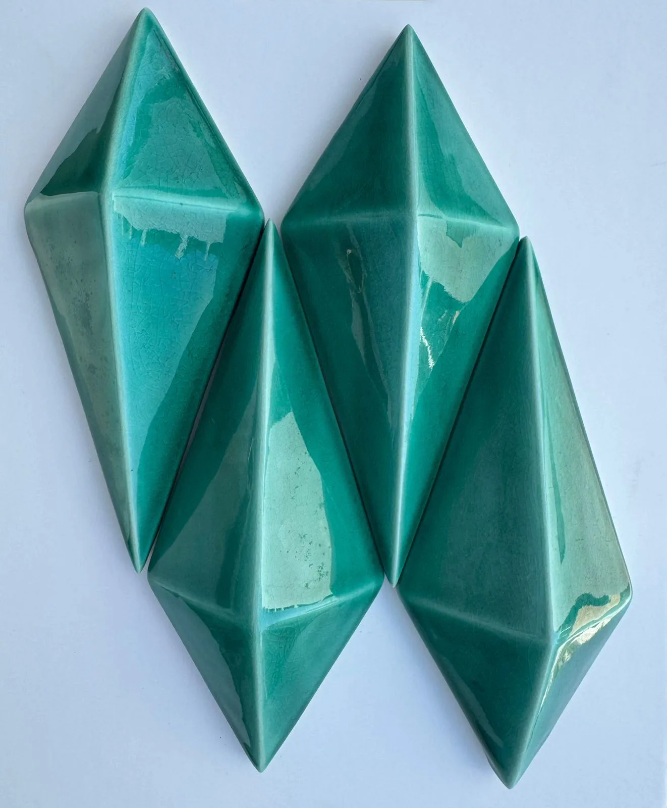 Teal diamond-shaped 3D glazed ceramic wall tiles.