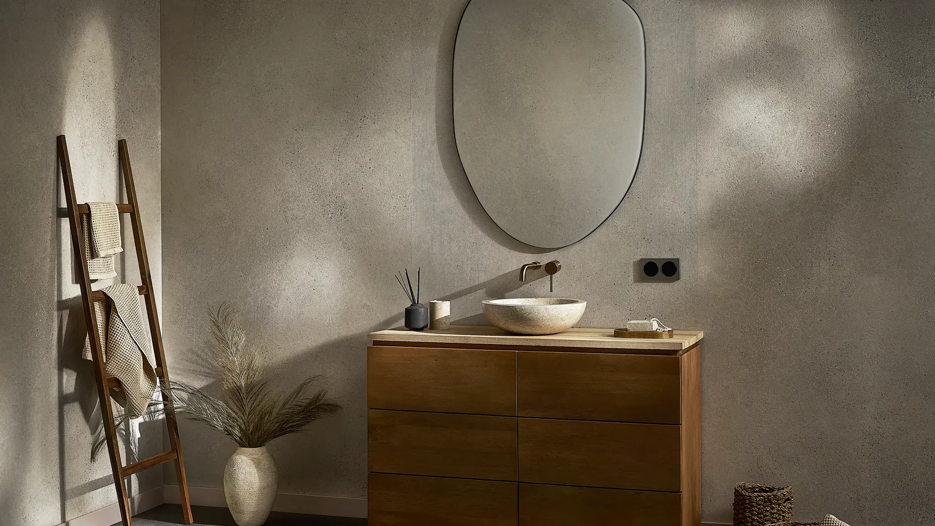 Modern bathroom vanity with a wood cabinet and textured mineral walls.