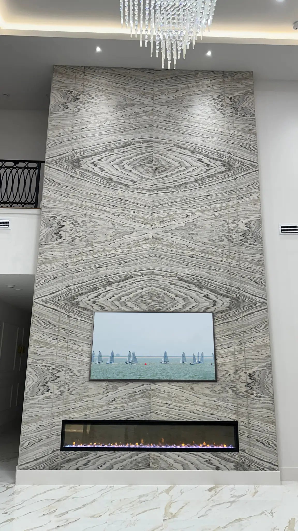 Real stone veneer — Bookmatched stone veneer fireplace wall.