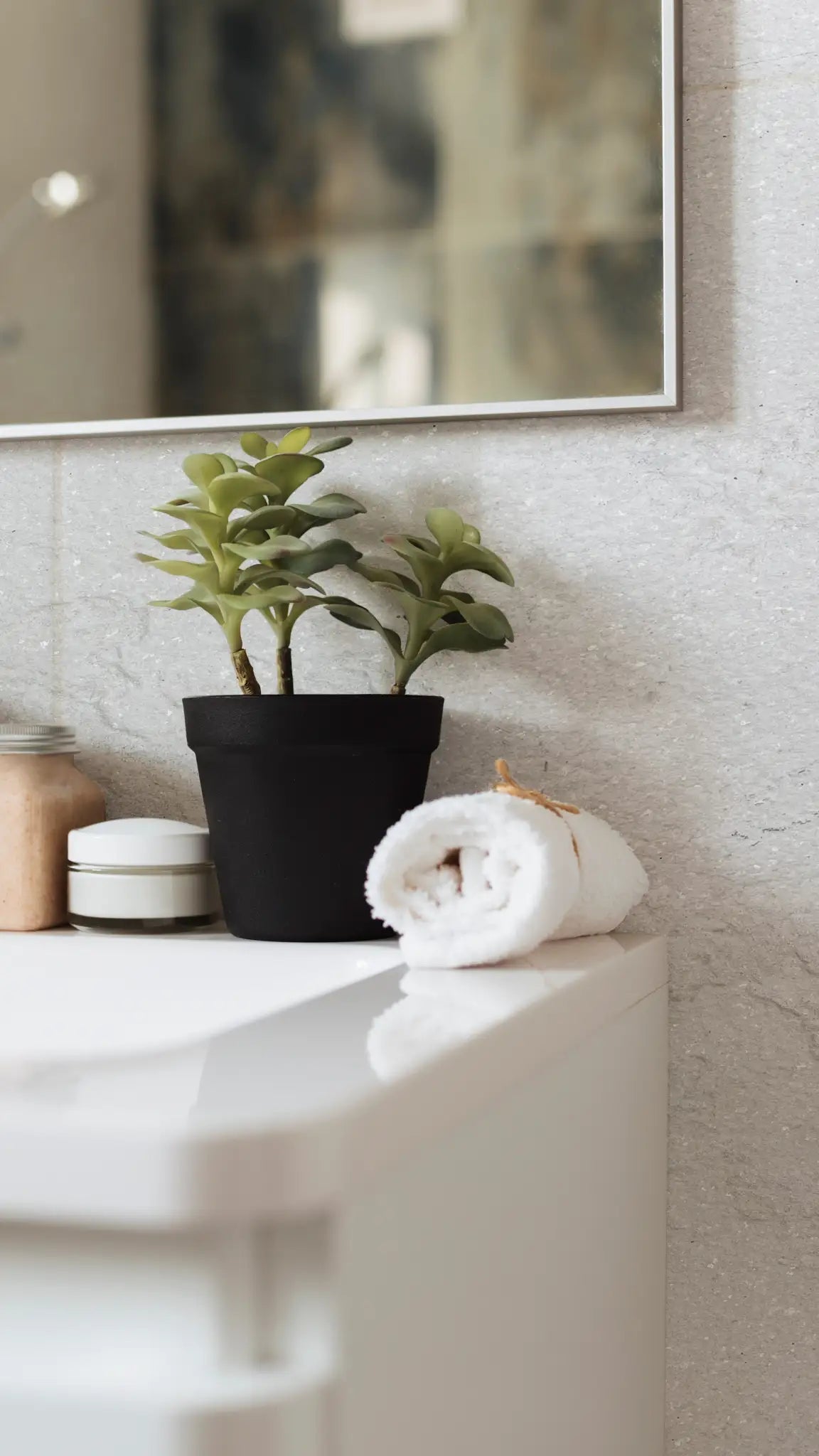 Real stone veneer — Textured stone veneer wall in a bathroom interior.