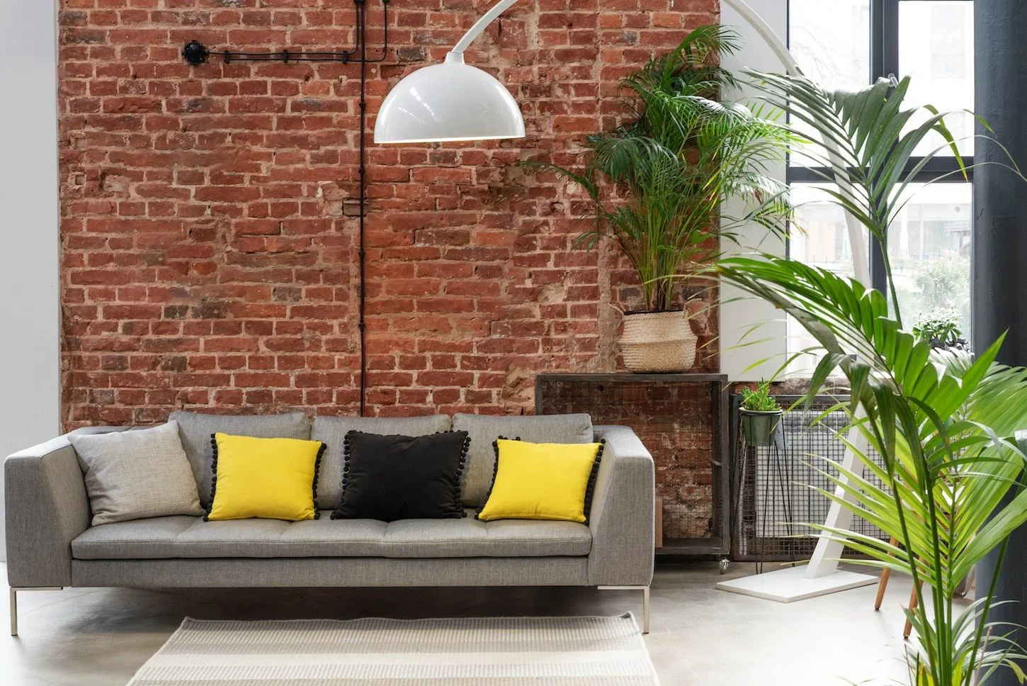 Modern living room interior with an exposed reclaimed brick feature wall.