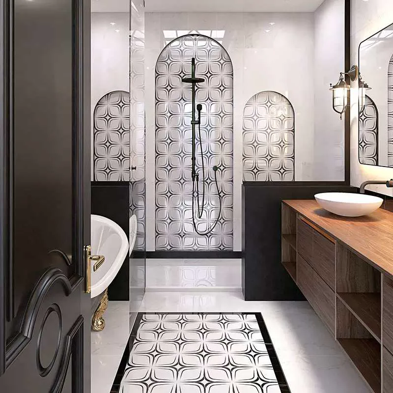 Finished bathroom with a black-and-white geometric mosaic on the shower wall and floor.
