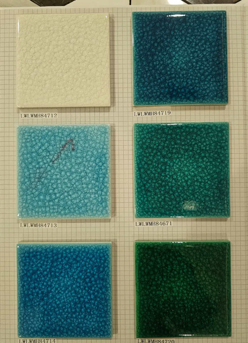 Large-format glazed swimming pool tile samples in pale aqua, teal, and green tones.