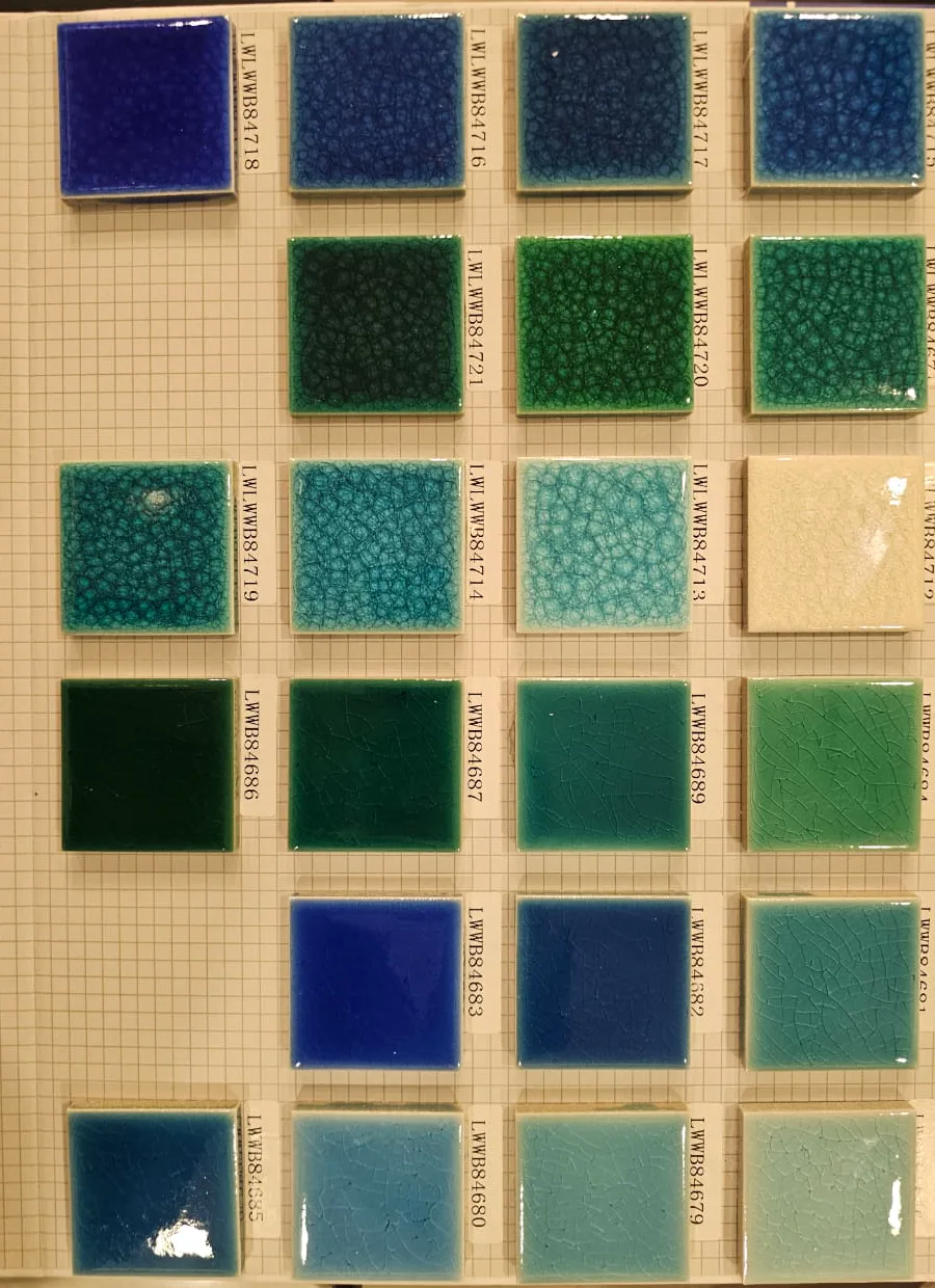 Glazed swimming pool tile samples arranged in deep blue, green, and seafoam tones.