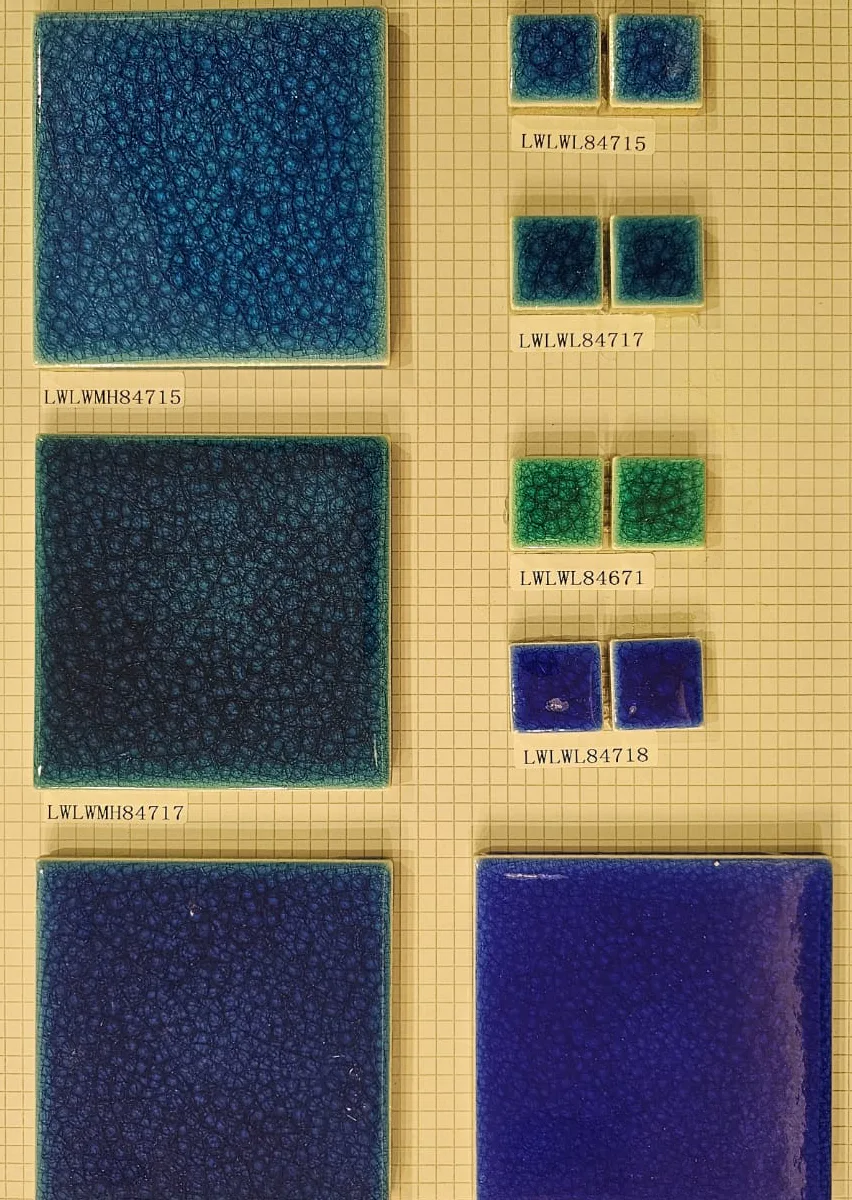 Glazed swimming pool tile samples in deep blue, indigo, and green with smaller companion pieces.