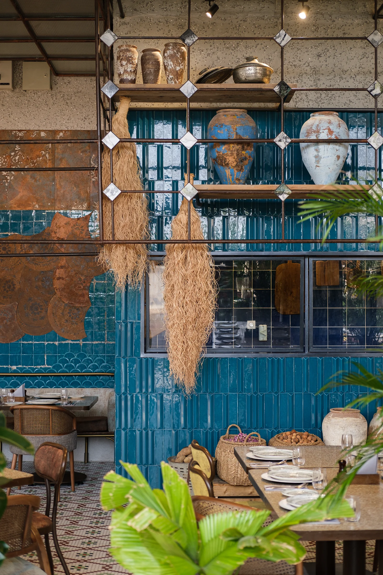 Restaurant dining space with handcrafted tilework and warm material tones.