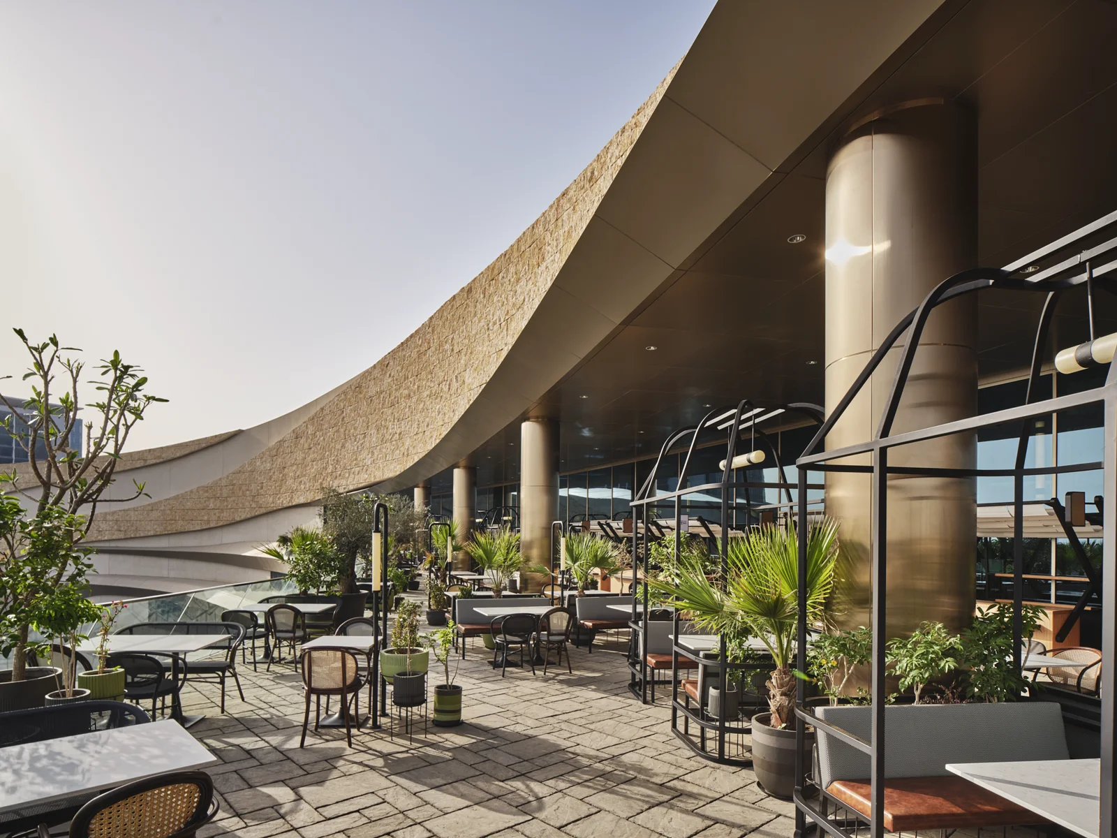 Outdoor architectural space with curved forms and considered paving details.